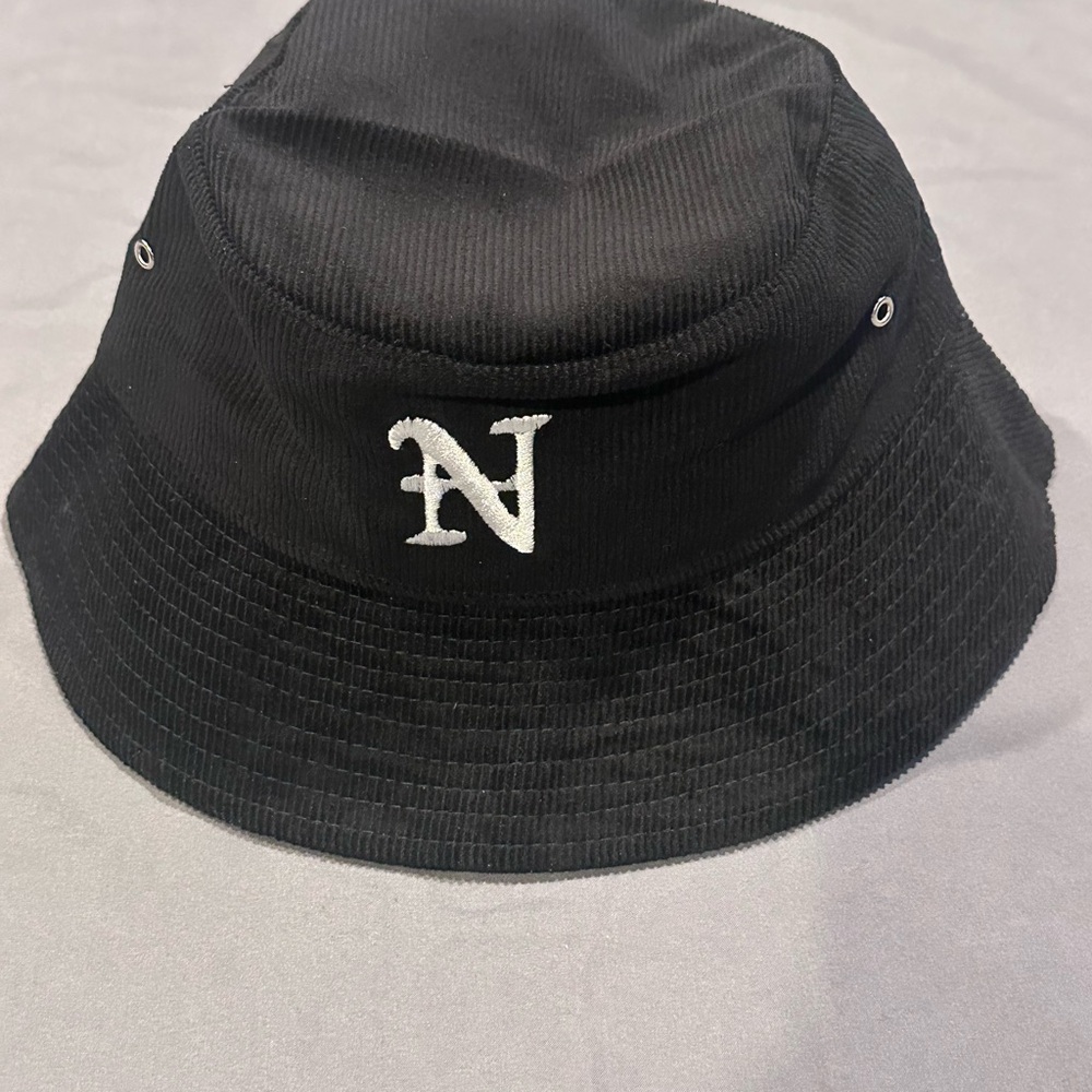 Nahmias corduroy bucket hat with an embroidered 'N' logo.